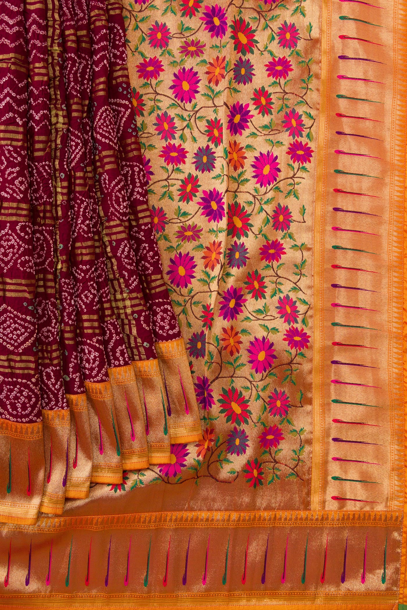 Pleats and pallu of Maroon Dual Tone Bandhani Silk Saree with Bandhani Print on the body and Paithani Border. 