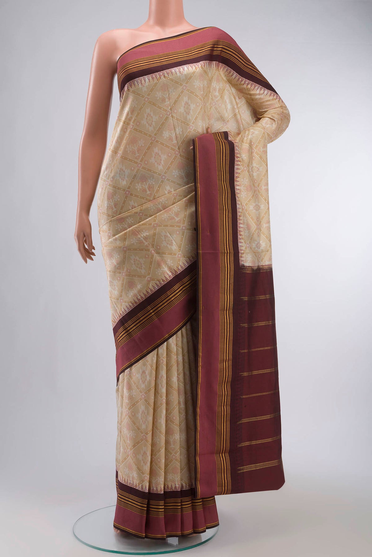 Beige Printed Silk Saree with Printed design on the body and Zari Border displayed on a mannequin