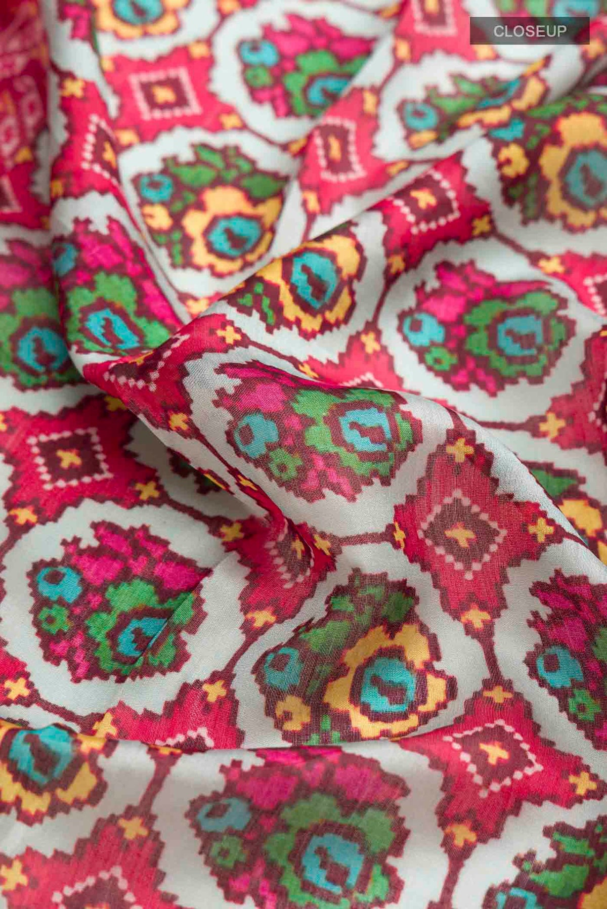 Close up of Grey Bhagalpuri Tussar Silk Saree with Printed design on the body and Zari Border displaying folds