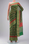 Green Tussar Silk Saree with Printed design on the body and Zari Border displayed on a mannequin