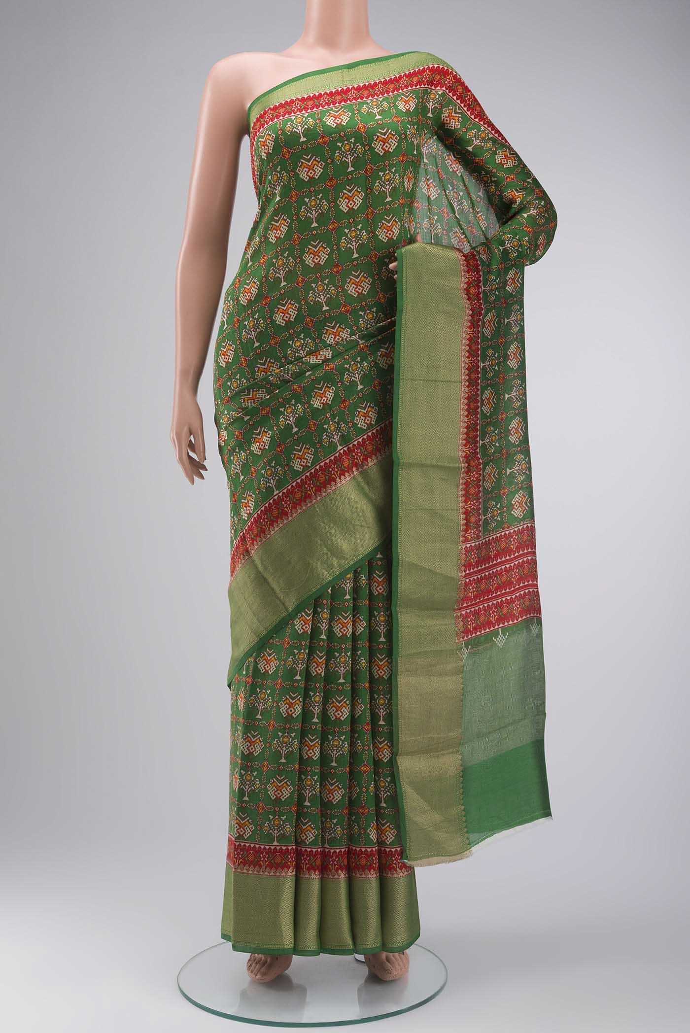 Green Tussar Silk Saree with Printed design on the body and Zari Border displayed on a mannequin