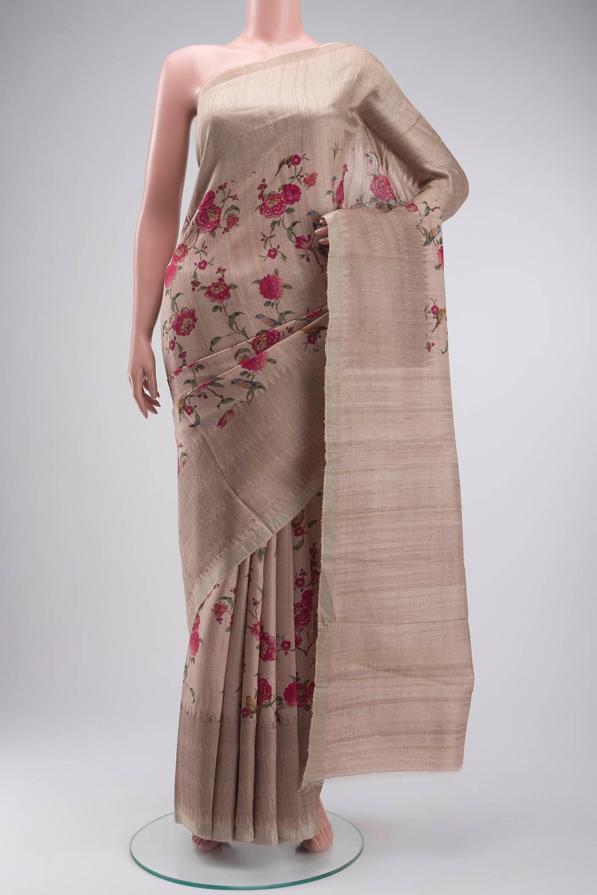 Beige Tussar Silk Saree with Printed design on the body and Zari Border displayed on a mannequin