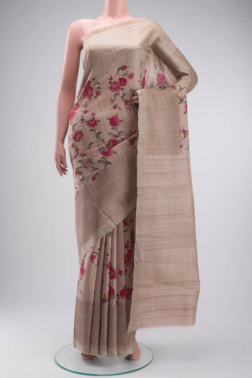 Beige Tussar Silk Saree with Printed design on the body and Zari Border displayed on a mannequin