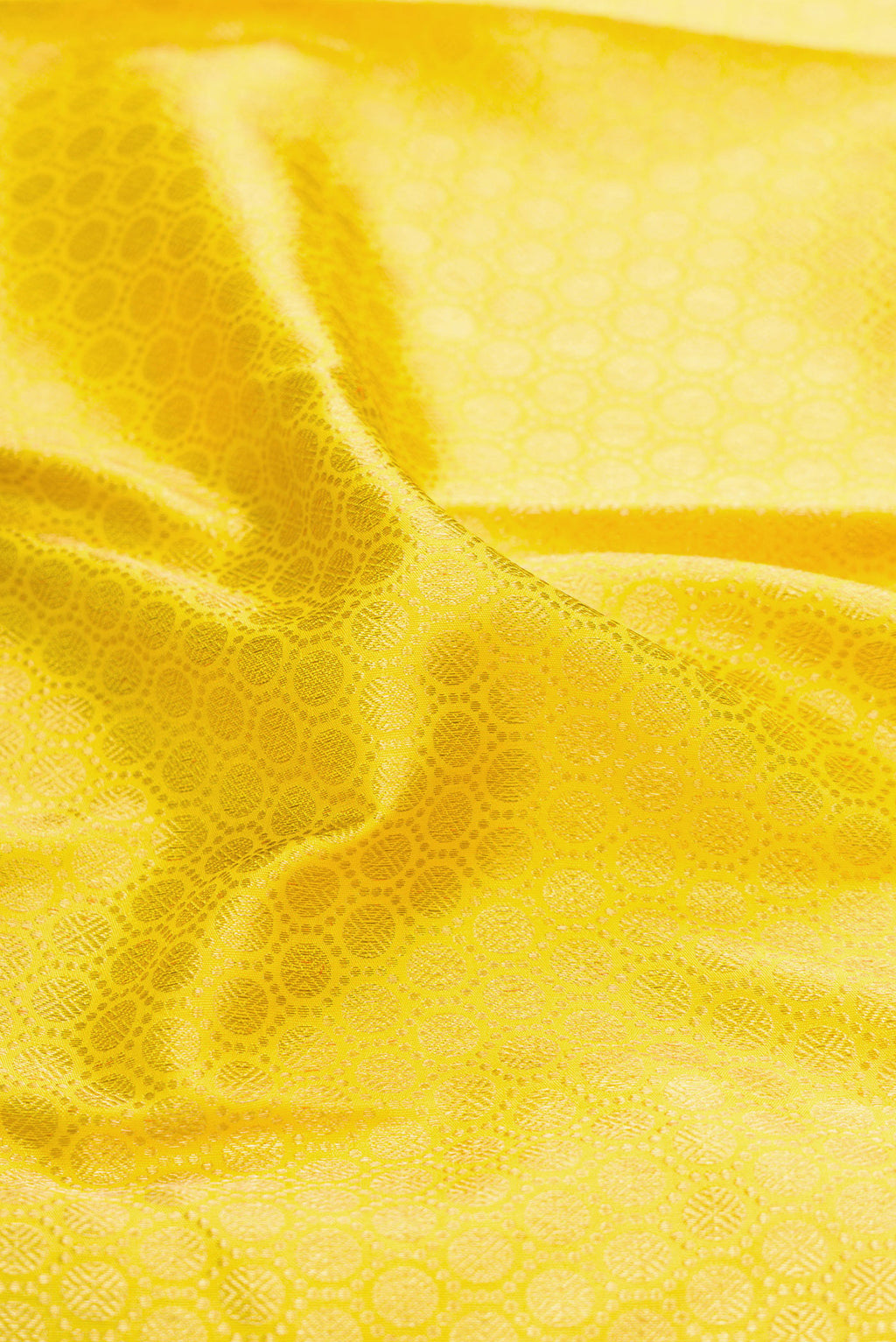 Close up of Pure Silk Pure Zari Parrot Green Dual Tone Kanjivaram Saree with Zari Brocade on the body and Zari Border.  displaying folds