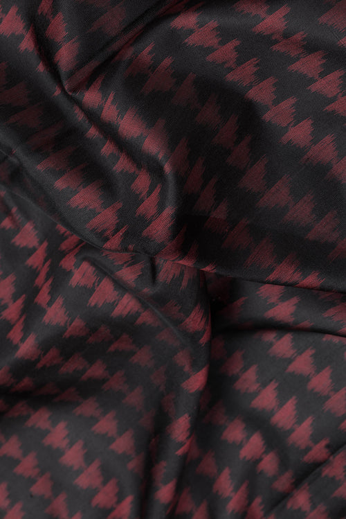 Close up of Black Dual Tone Double Ikat Saree with Ikat Print on the body and Fancy Border.  displaying folds