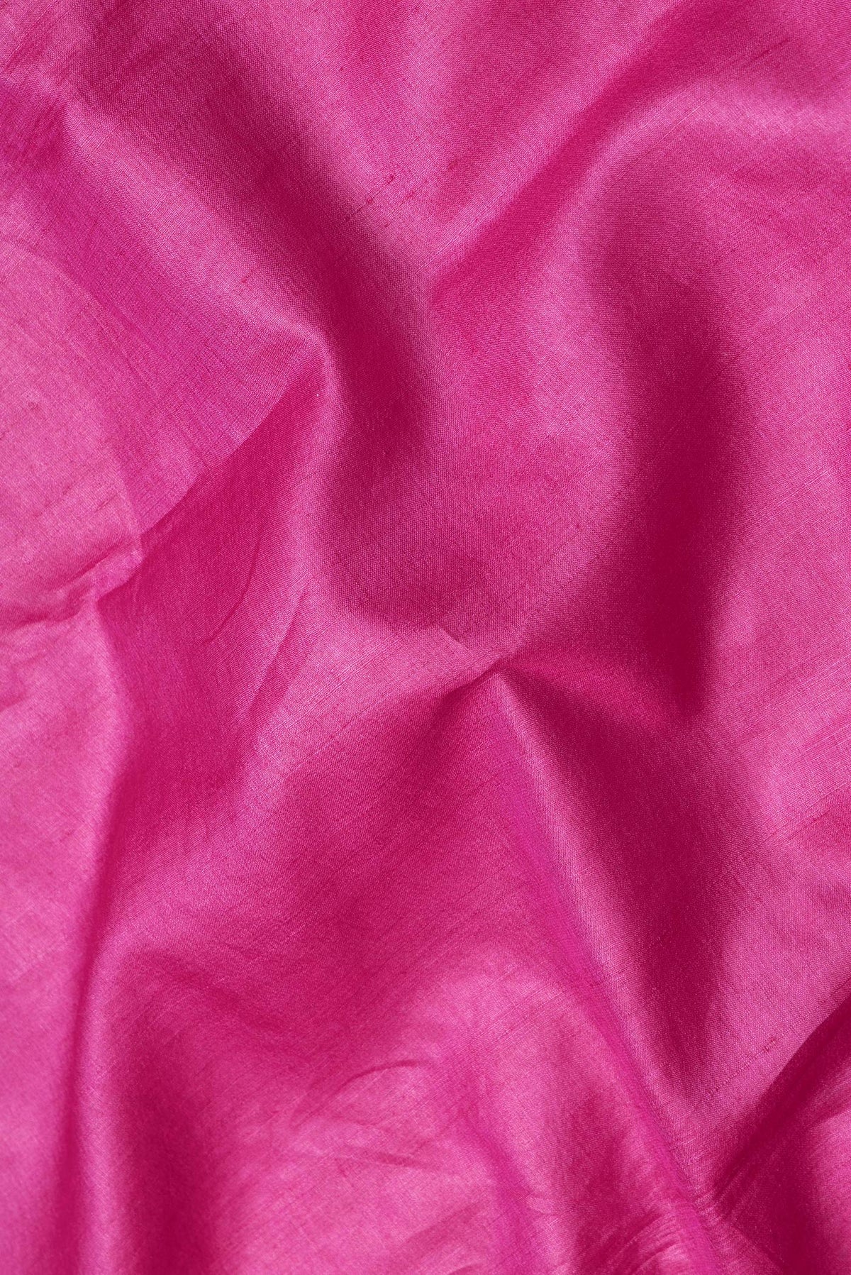 Close up of Pink Dual Tone Tussar Silk Saree with Plain Body and Embroidery Border.  displaying folds