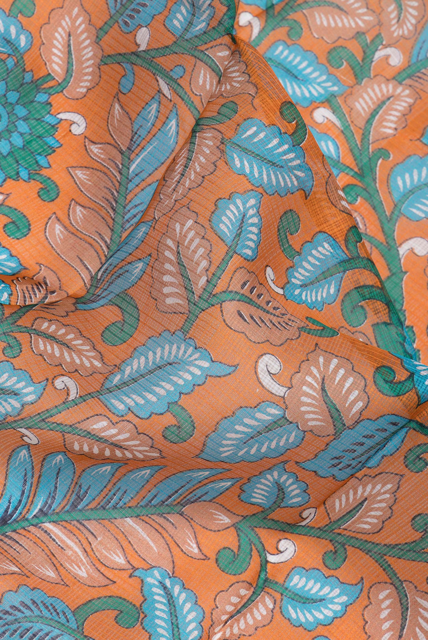 Close up of Orange Kota Silk Saree with Printed design on the body and Zari Border.  displaying folds