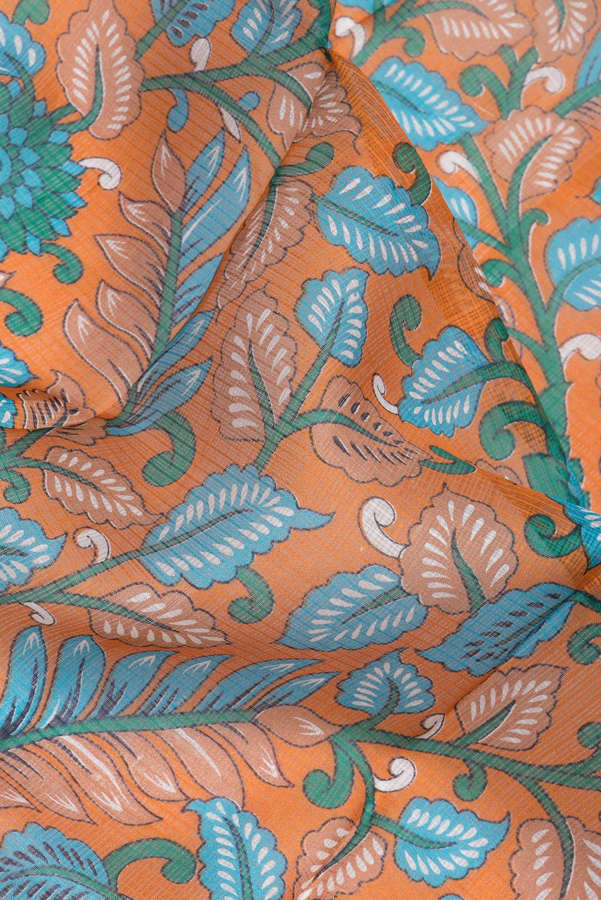 Close up of Orange Kota Silk Saree with Printed design on the body and Zari Border.  displaying folds
