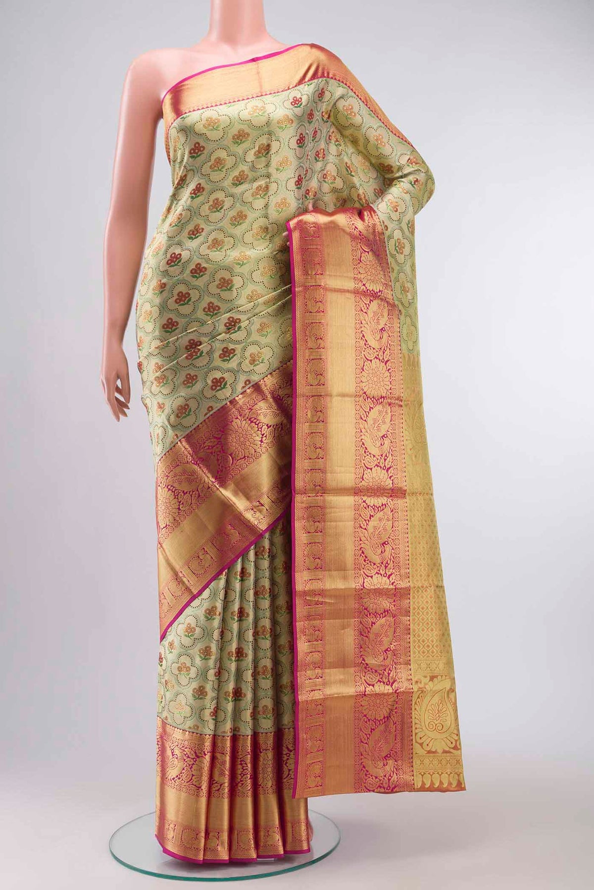 Gold with Green Color Kanchipuram Tissue Silk Saree with Zari Brocade on the body and Zari Border displayed on a mannequin