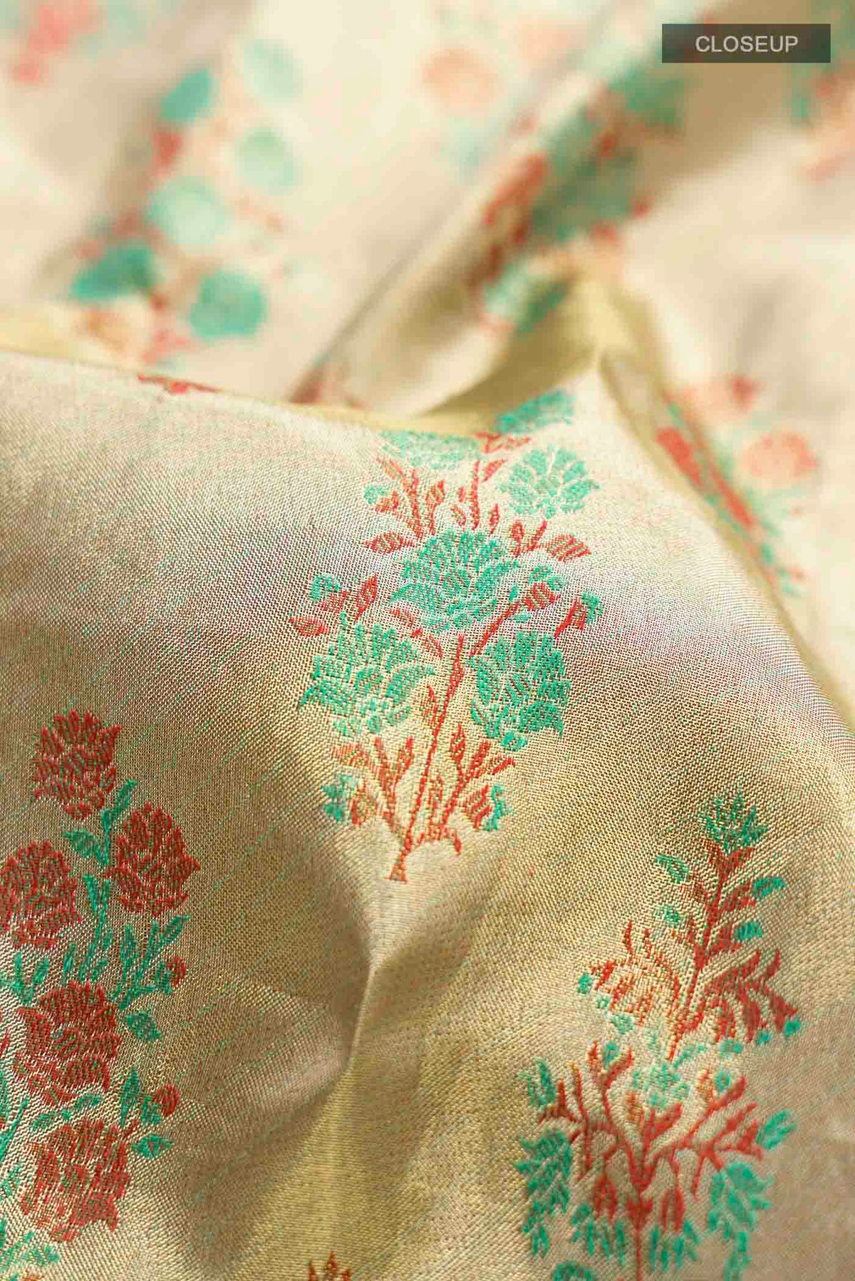 Close up of Gold with Red Color Kanchipuram Tissue Silk Saree with Zari Brocade on the body and Zari Border displaying folds