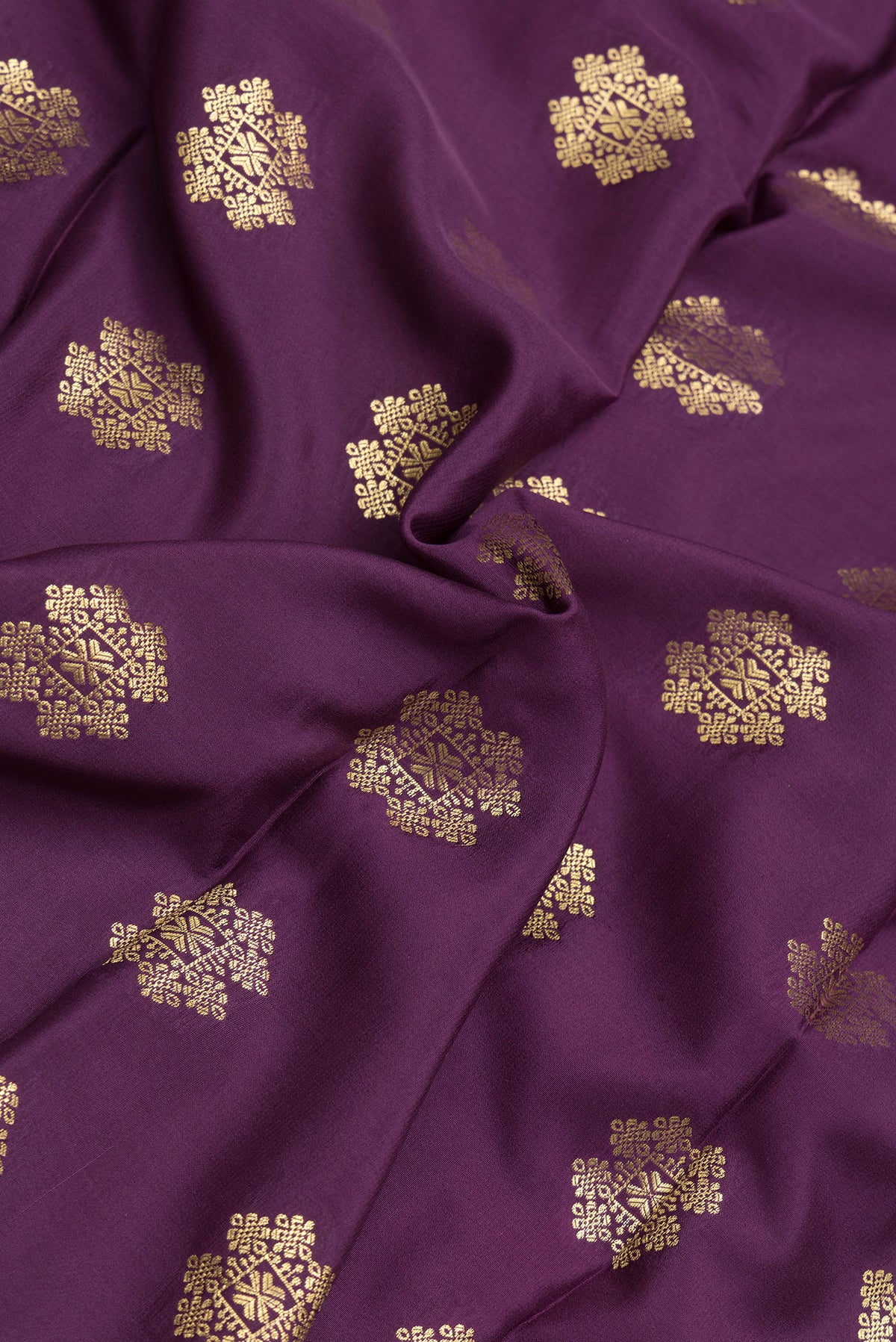 Close up of Burgundy Dual Tone Mysore Silk Saree with Zari Butta on the body and Zari Border.  displaying folds