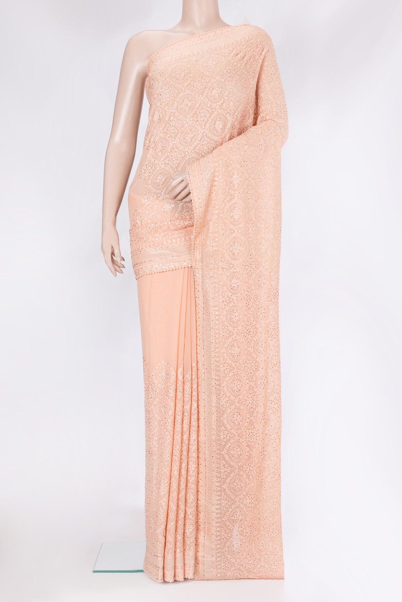 Peach Georgette Saree with Embroidery on the body and Embroidery Border.  displayed on a mannequin