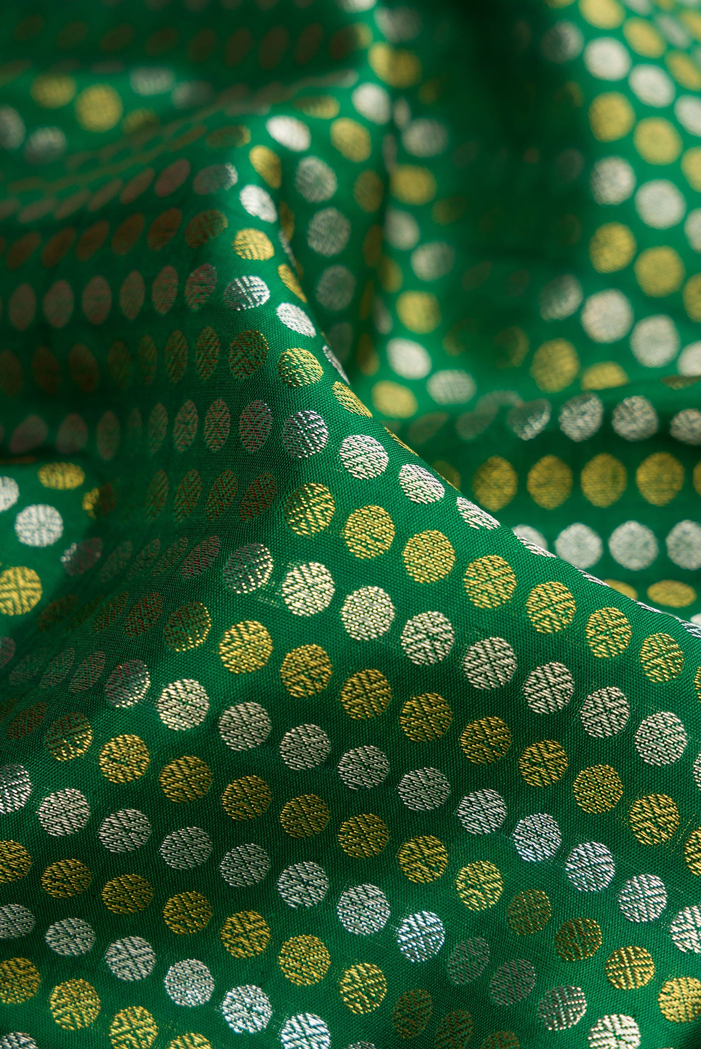 Close up of Green Kanjivaram Silk Saree with Zari Brocade on the body and Zari Border.  displaying folds
