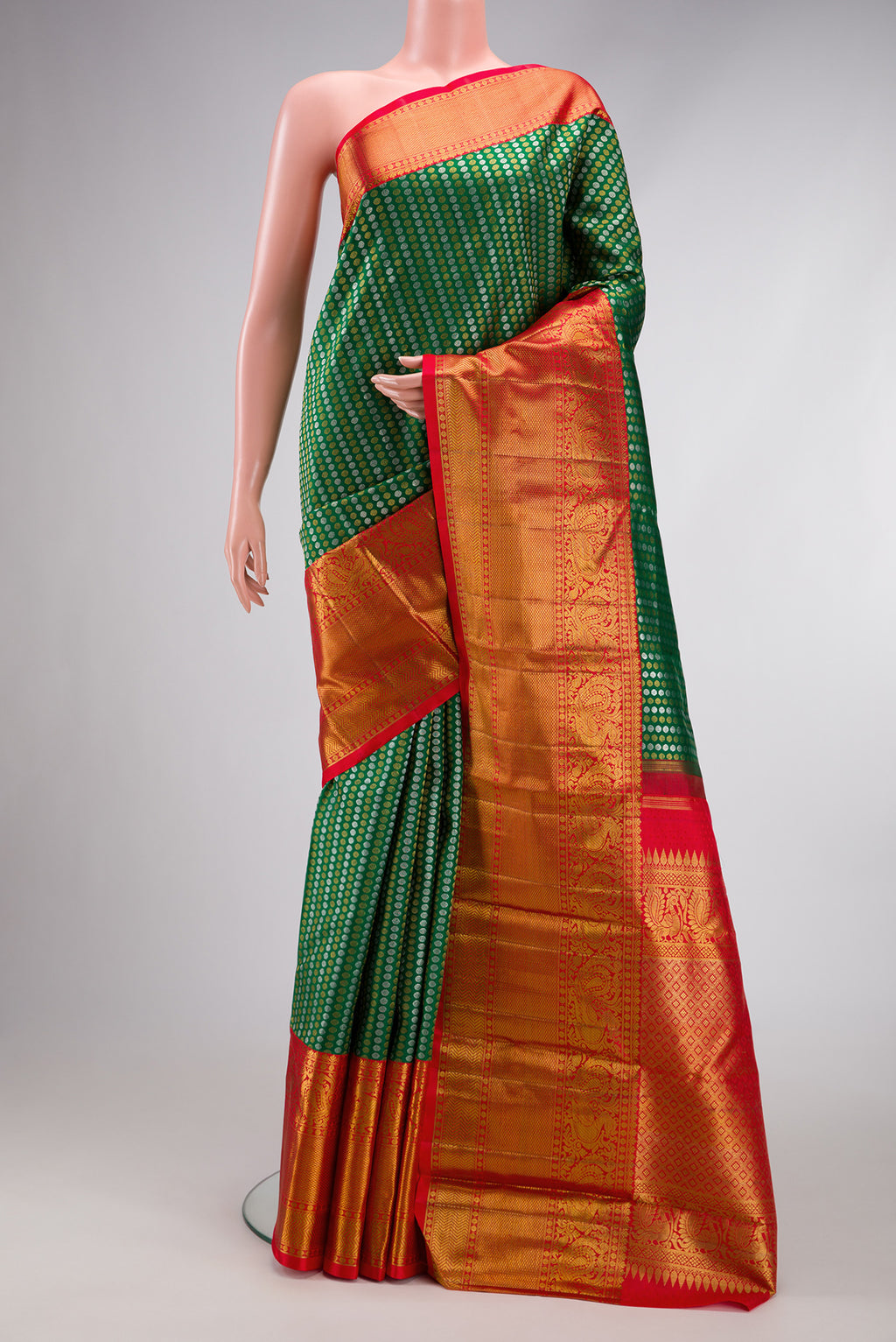 Green Kanjivaram Silk Saree with Zari Brocade on the body and Zari Border.  displayed on a mannequin