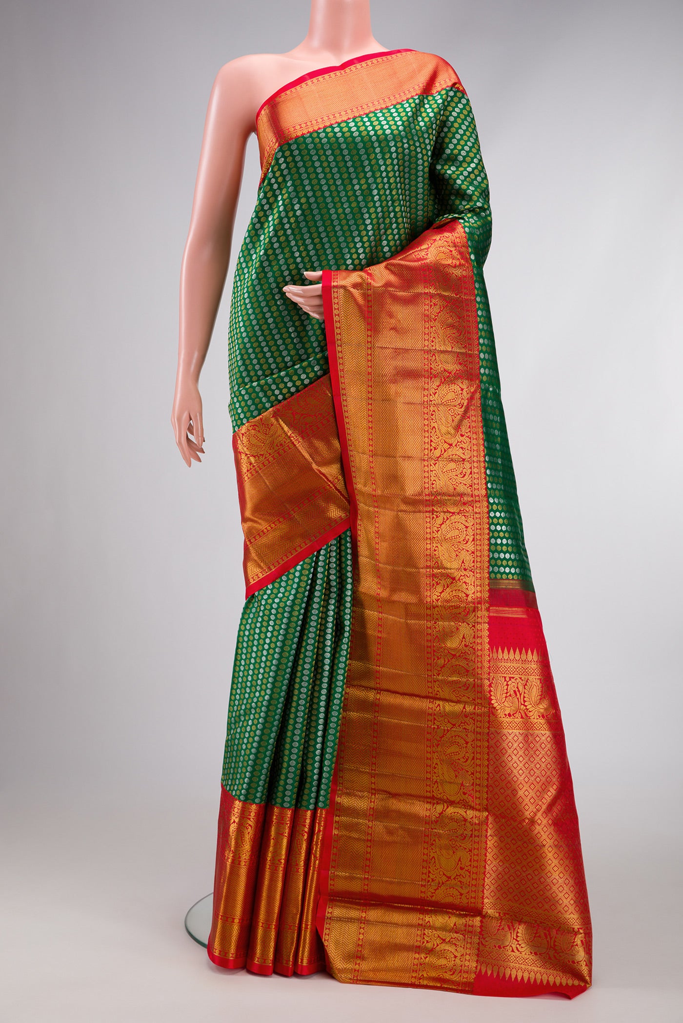 Green Kanjivaram Silk Saree with Zari Brocade on the body and Zari Border.  displayed on a mannequin