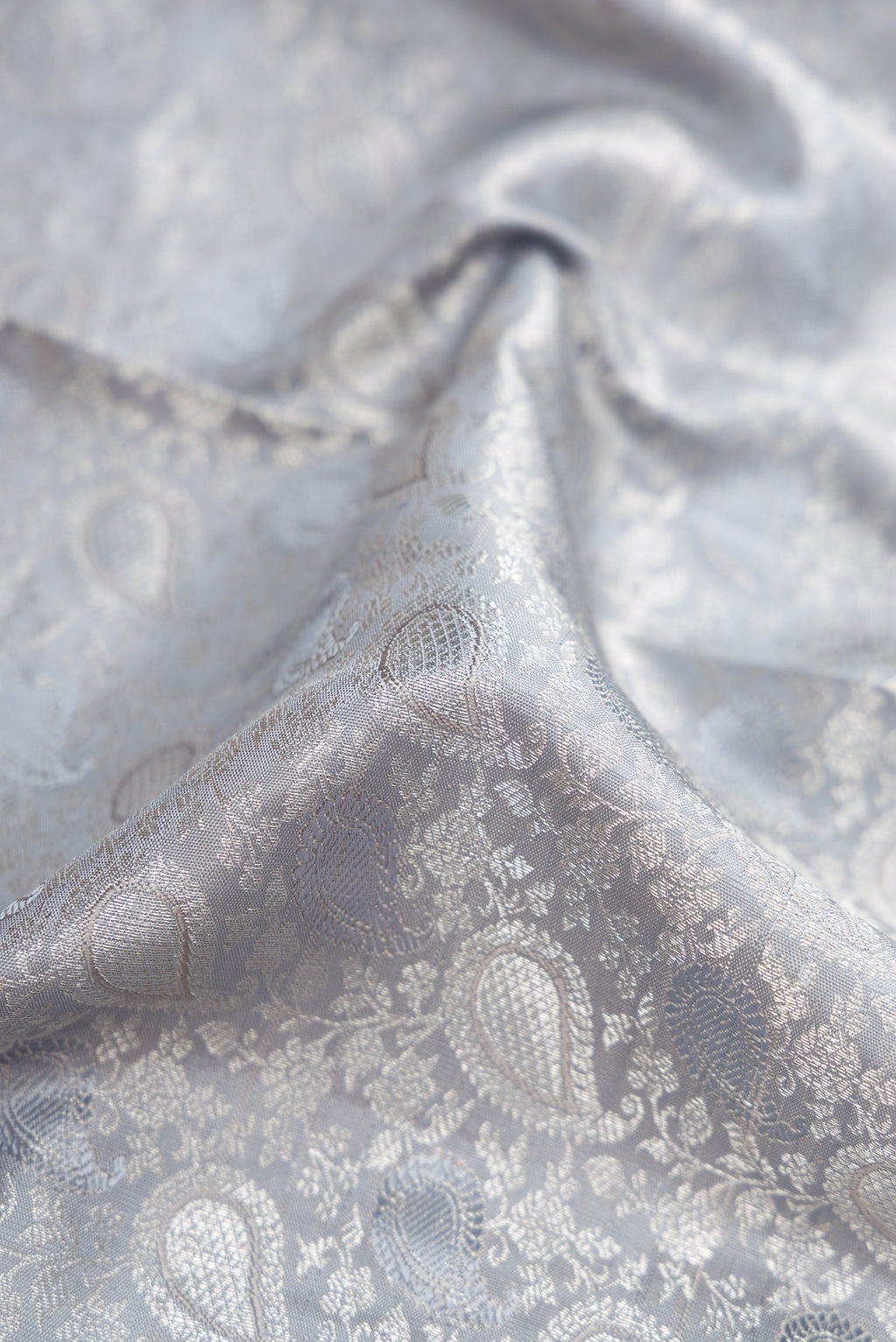 Close up of Grey Dual Tone Kanchipuram Silk Saree with Jacquard With Zari Butta on the body and Zari Border.  displaying folds