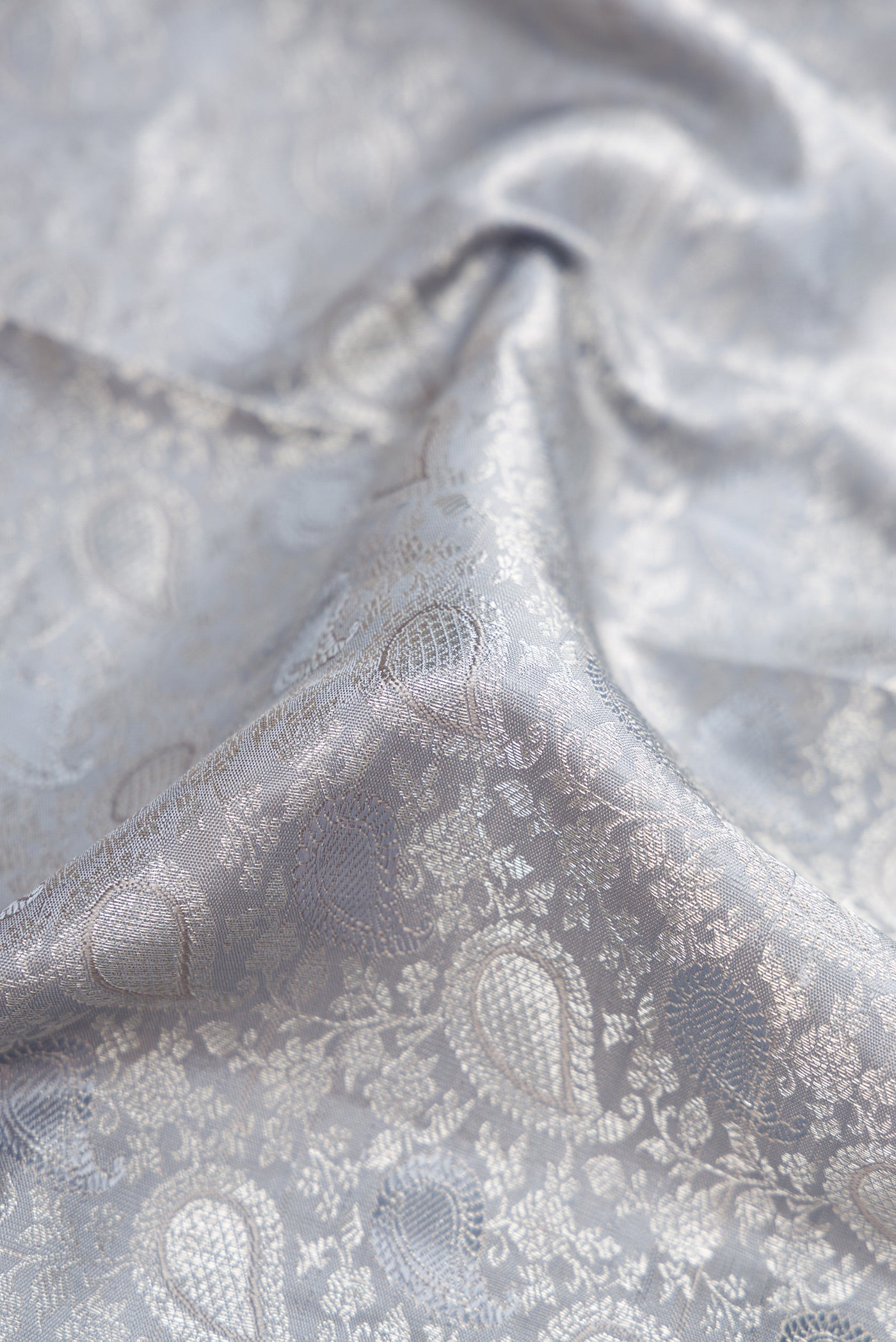 Close up of Grey Dual Tone Kanchipuram Silk Saree with Jacquard With Zari Butta on the body and Zari Border.  displaying folds
