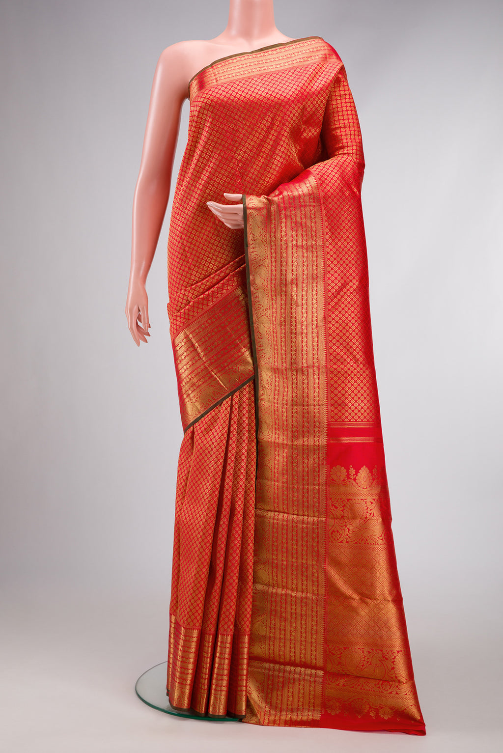 Pure Silk Pure Zari Red Kanjivaram Saree with Zari Brocade on the body and Zari Border.  displayed on a mannequin
