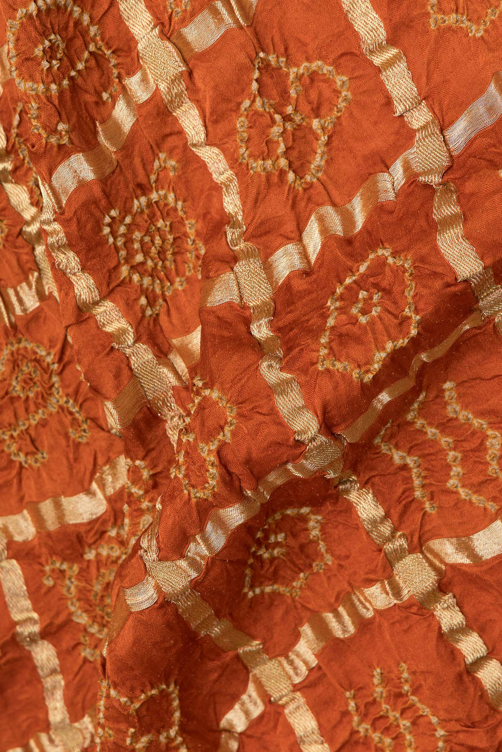 Close up of Pure Silk Orange Bandhani Saree with Bandhani on the body and Without Border.  displaying folds