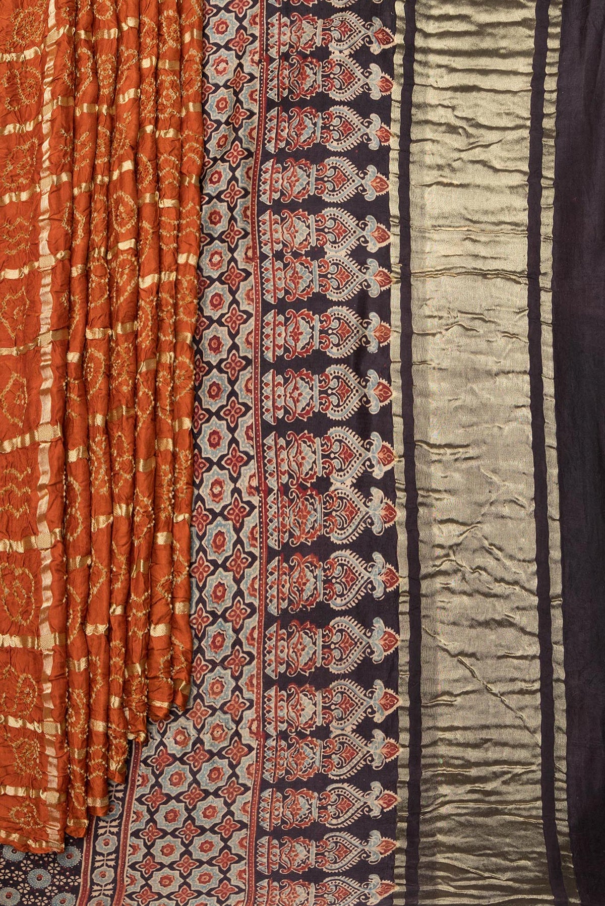 Pleats and pallu of Pure Silk Orange Bandhani Saree with Bandhani on the body and Without Border. 