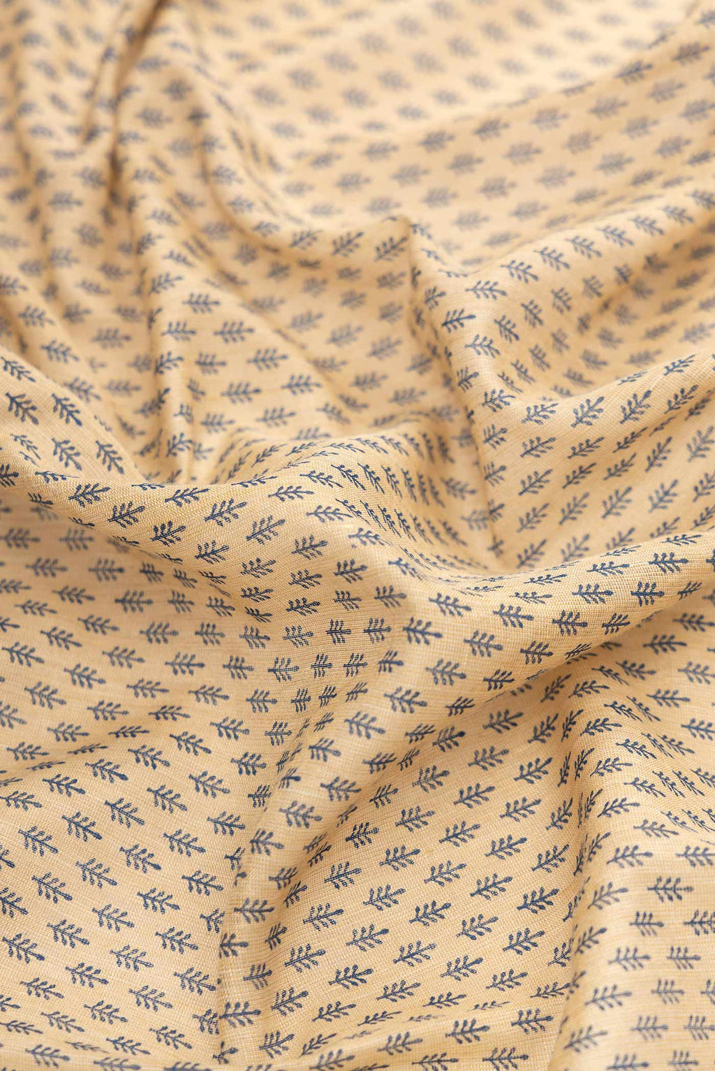 Close up of Beige Dual Tone Tussar Silk Saree with Printed design on the body and Zari Border.  displaying folds