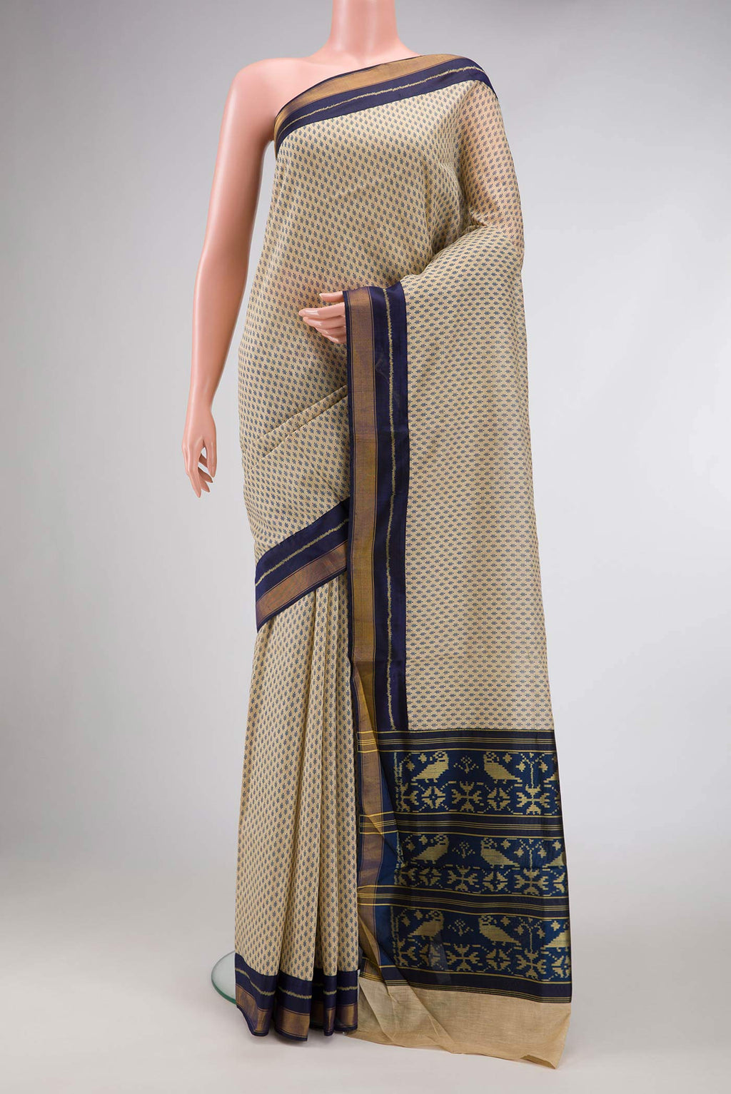 Beige Dual Tone Tussar Silk Saree with Printed design on the body and Zari Border.  displayed on a mannequin