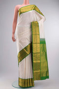 White Kanchipuram Silk Saree with Plain Body and Zari Border displayed on a mannequin