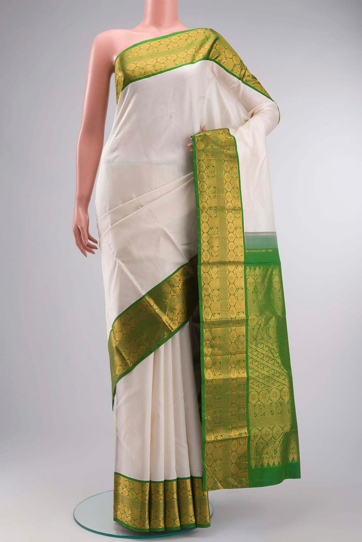 White Kanchipuram Silk Saree with Plain Body and Zari Border displayed on a mannequin