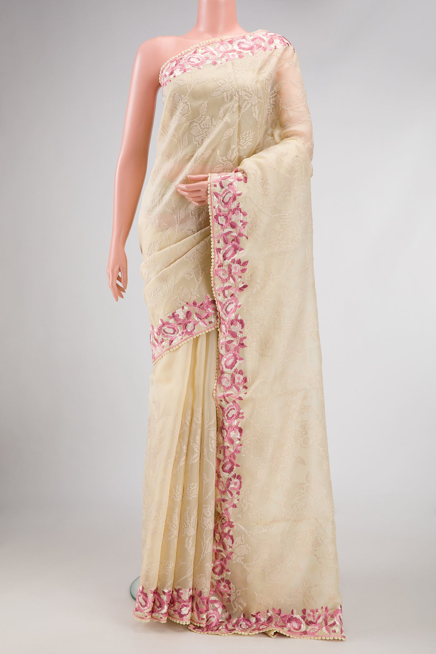 Beige Dual Tone Organza Silk Saree with Embroidery on the body and Embroidery Border.  displayed on a mannequin