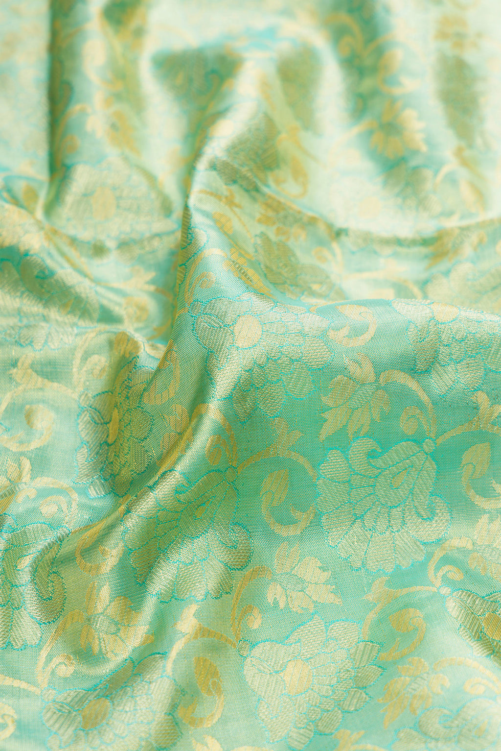 Close up of Sky Blue Dual Tone Kanchipuram Tissue Silk Saree with Zari Brocade on the body and Zari Border.  displaying folds