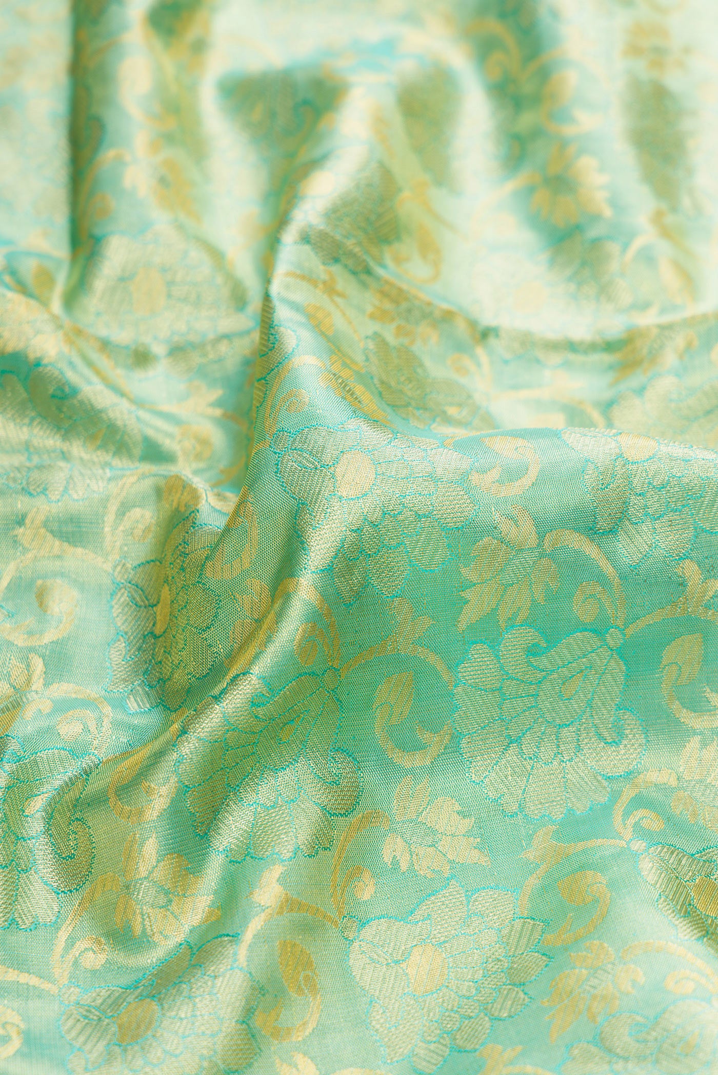Close up of Sky Blue Dual Tone Kanchipuram Tissue Silk Saree with Zari Brocade on the body and Zari Border.  displaying folds
