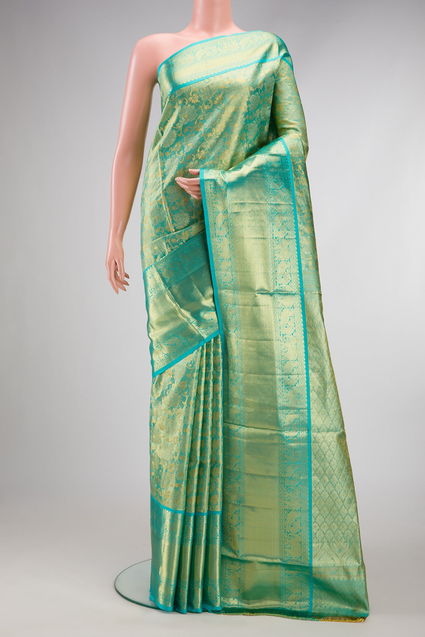 Sky Blue Dual Tone Kanchipuram Tissue Silk Saree with Zari Brocade on the body and Zari Border.  displayed on a mannequin