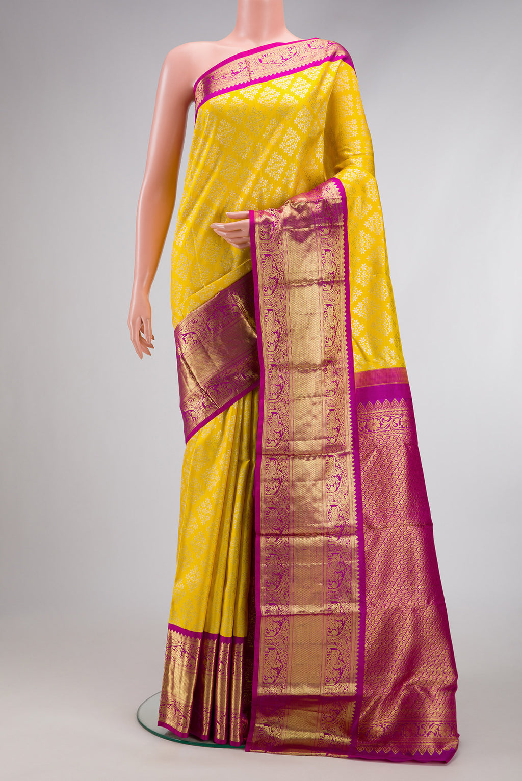 Yellow Dual Tone Kanjivaram Silk Saree with Zari Brocade on the body and Zari Border.  displayed on a mannequin
