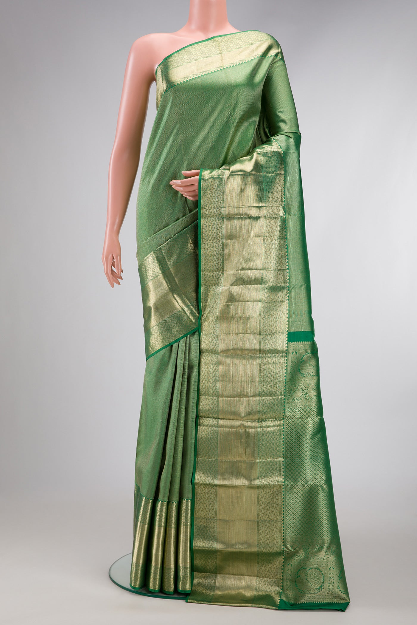 Pista Green Dual Tone Kanchipuram Silk Saree with Zari Brocade on the body and Zari Border.  displayed on a mannequin