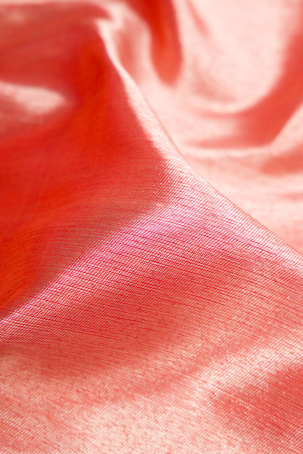 Close up of Coral Dual Tone Kanchipuram Silk Saree with Zari Brocade on the body and Fancy Border.  displaying folds