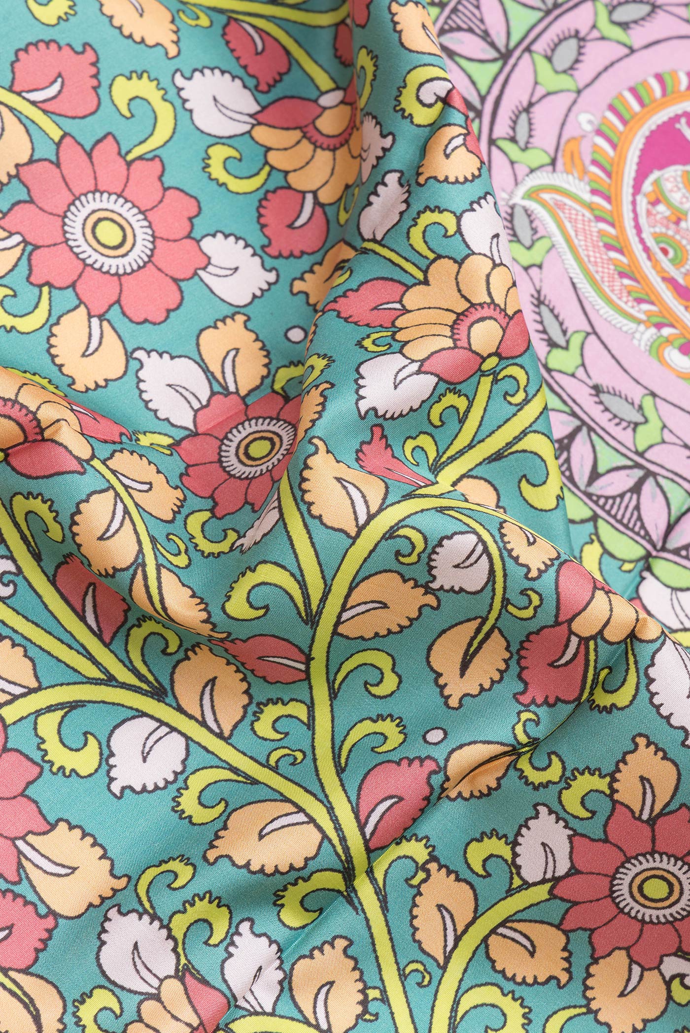 Close up of Sea Green Dual Tone Kanjivaram Silk Saree with kalamkari Print on the body and Zari Border.  displaying folds