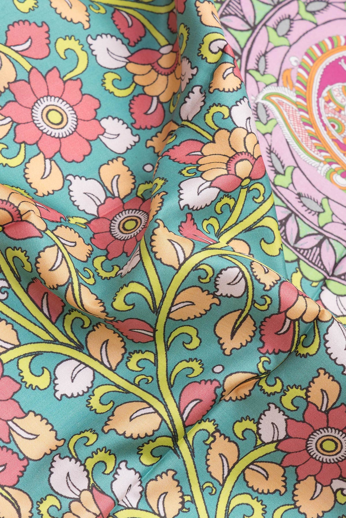 Close up of Sea Green Dual Tone Kanjivaram Silk Saree with kalamkari Print on the body and Zari Border.  displaying folds