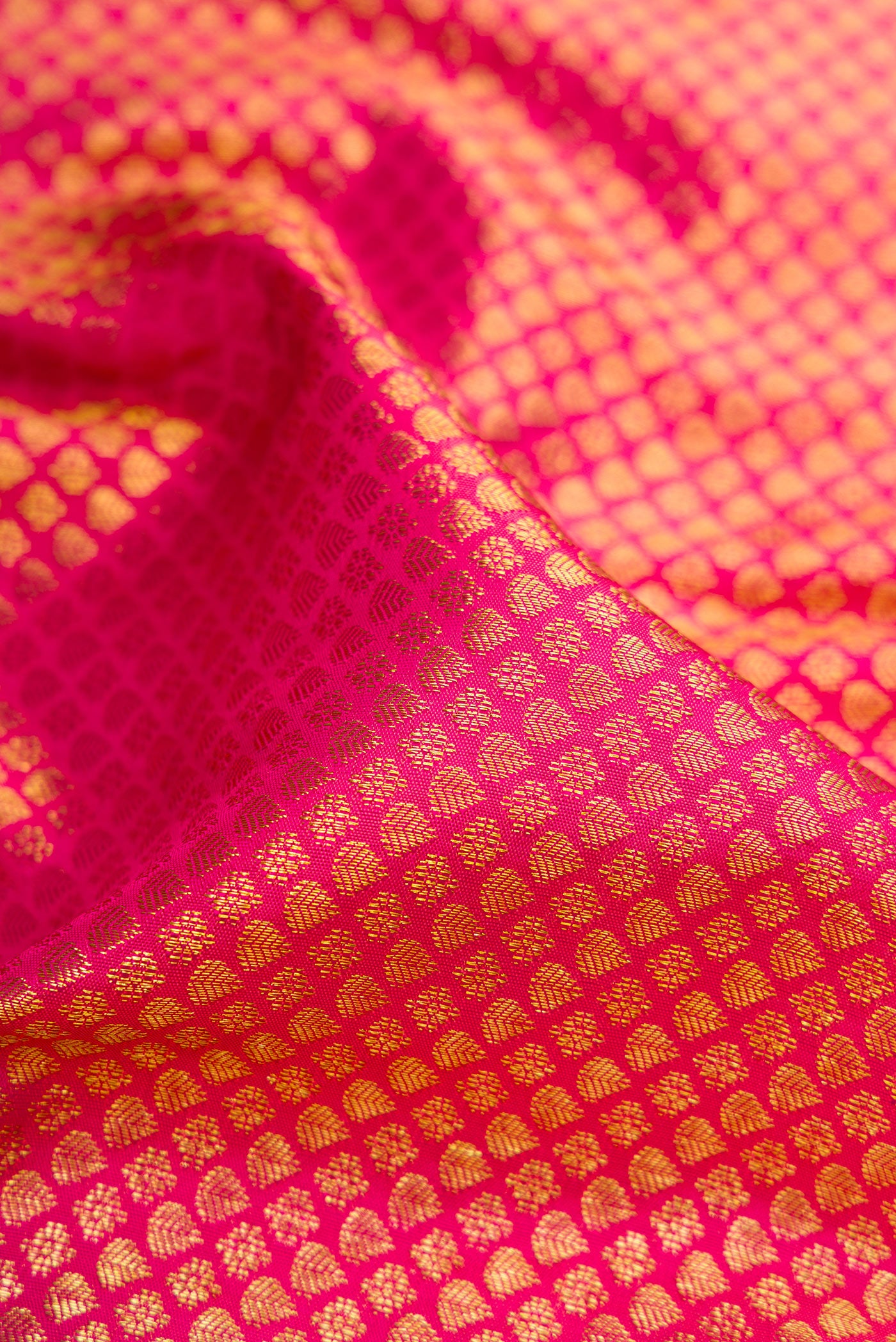 Close up of Pink Dual Tone Kanchipuram Silk Saree with Zari Brocade on the body and Zari Border.  displaying folds