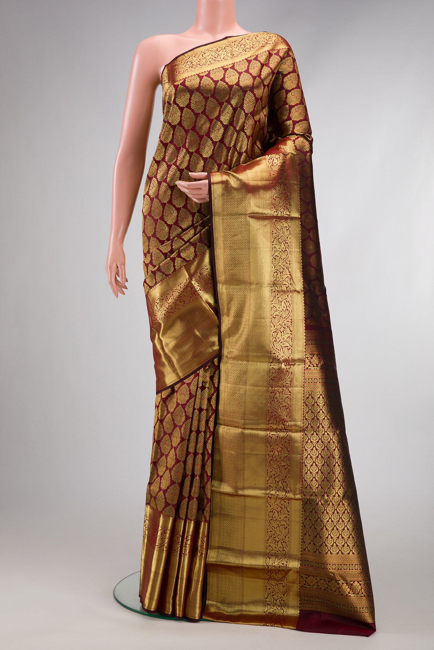 Maroon Dual Tone Kanjivaram Silk Saree with Zari Brocade on the body and Zari Border.  displayed on a mannequin