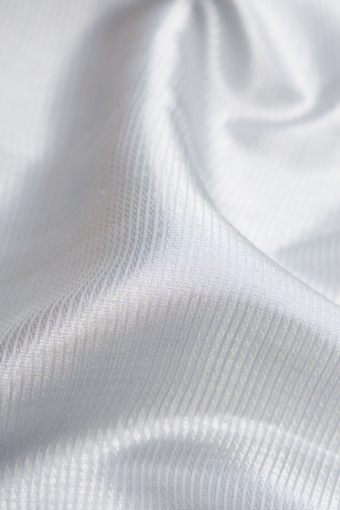 Close up of Grey Dual Tone Kanchipuram Silk Saree with Zari Brocade on the body and Zari Border.  displaying folds
