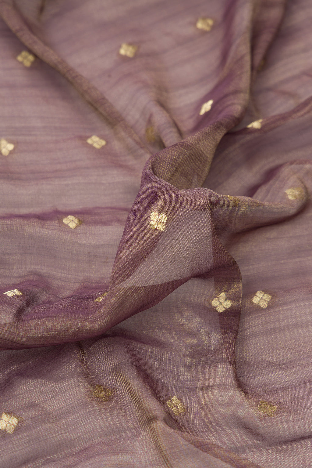 Close up of Brown Dual Tone Tussar Silk Saree with Zari Butta on the body and Zari Border.  displaying folds