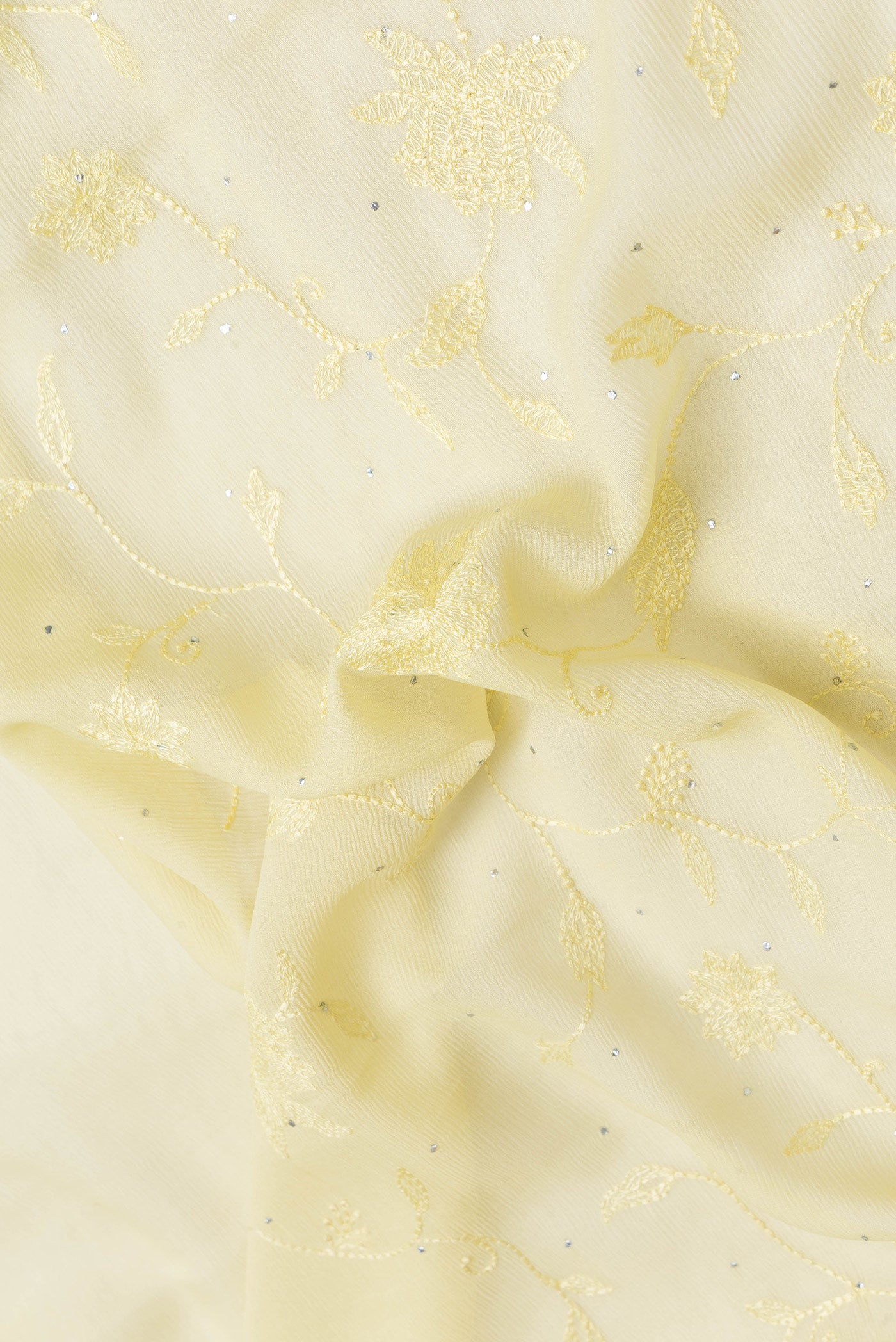 Close up of Lemon Yellow Dual Tone Mysore Chiffon Saree with Embroidery on the body and Embroidery Border.  displaying folds