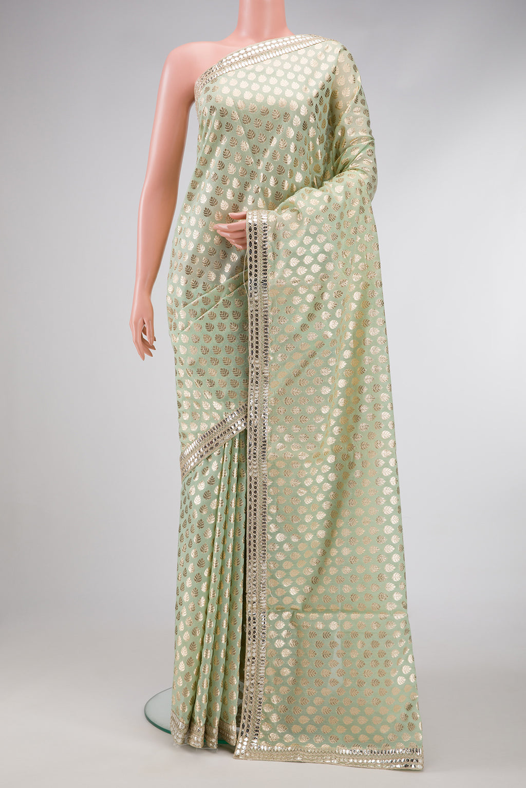 Pista Green Dual Tone Organza Silk Saree with Zari Brocade on the body and Embroidery Border.  displayed on a mannequin