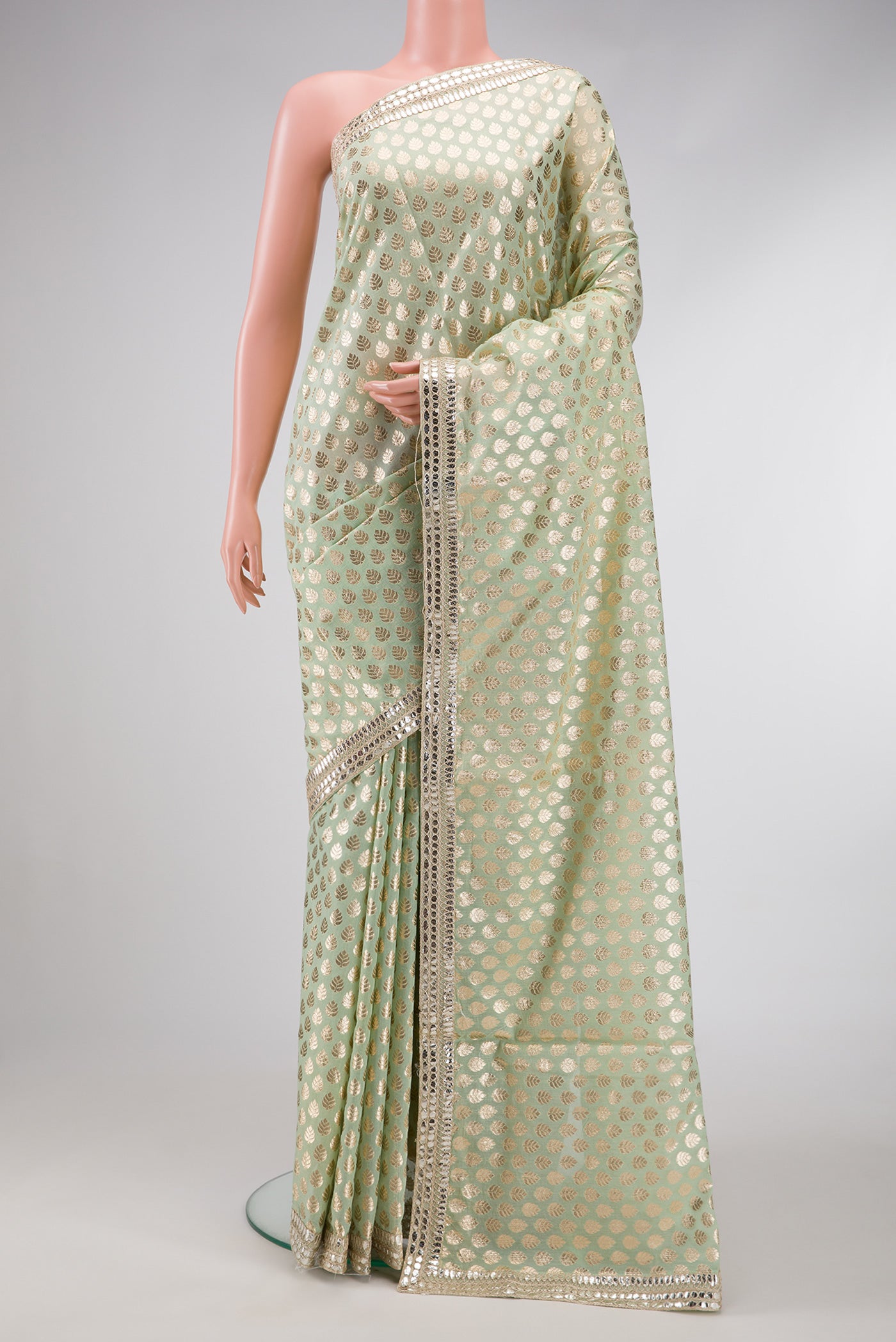 Pista Green Dual Tone Organza Silk Saree with Zari Brocade on the body and Embroidery Border.  displayed on a mannequin