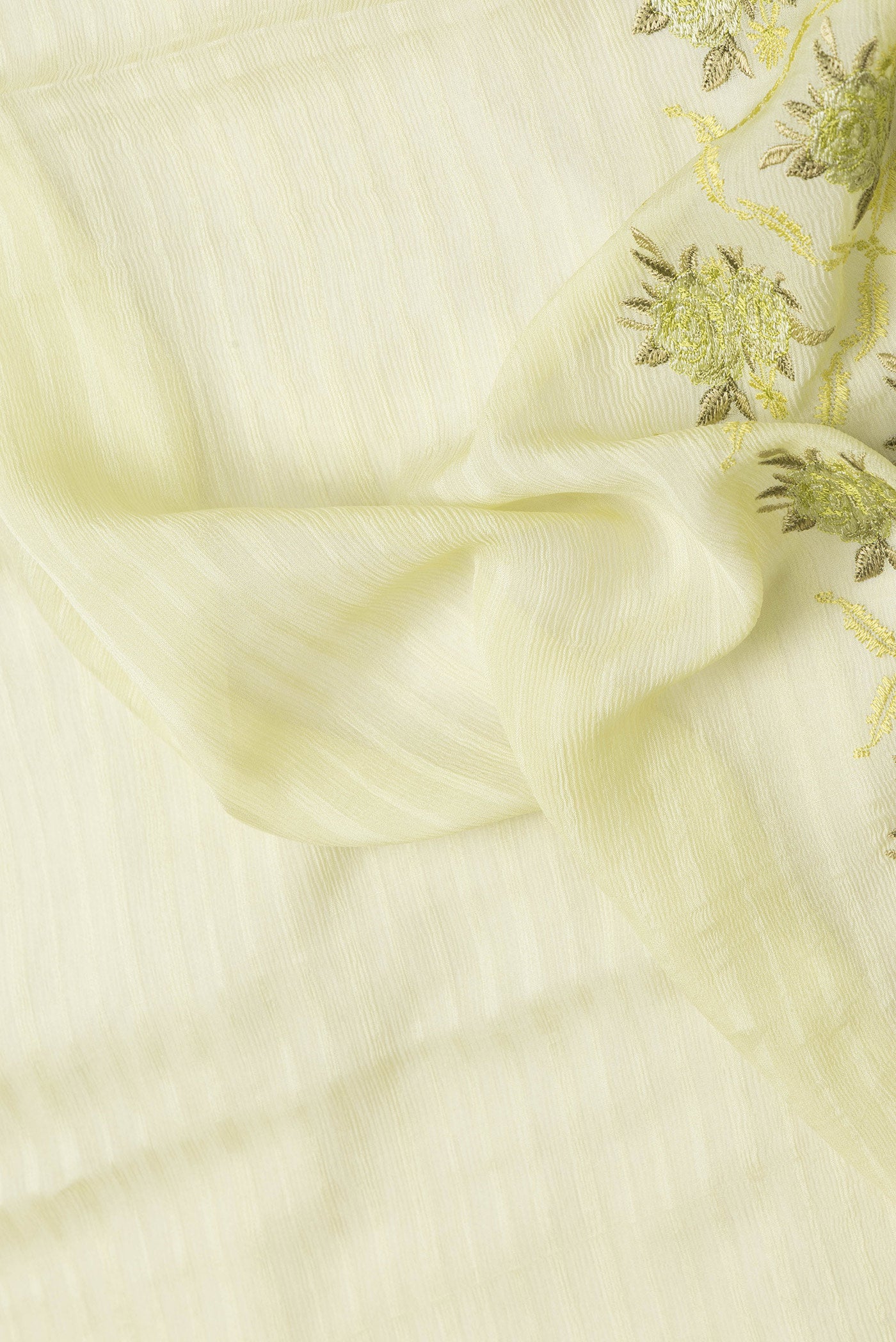 Close up of Pista Green Dual Tone Mysore Chiffon Saree with Stripes on the body and Embroidery Border.  displaying folds
