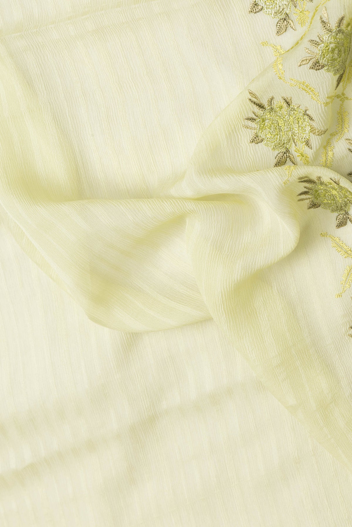Close up of Pista Green Dual Tone Mysore Chiffon Saree with Stripes on the body and Embroidery Border.  displaying folds