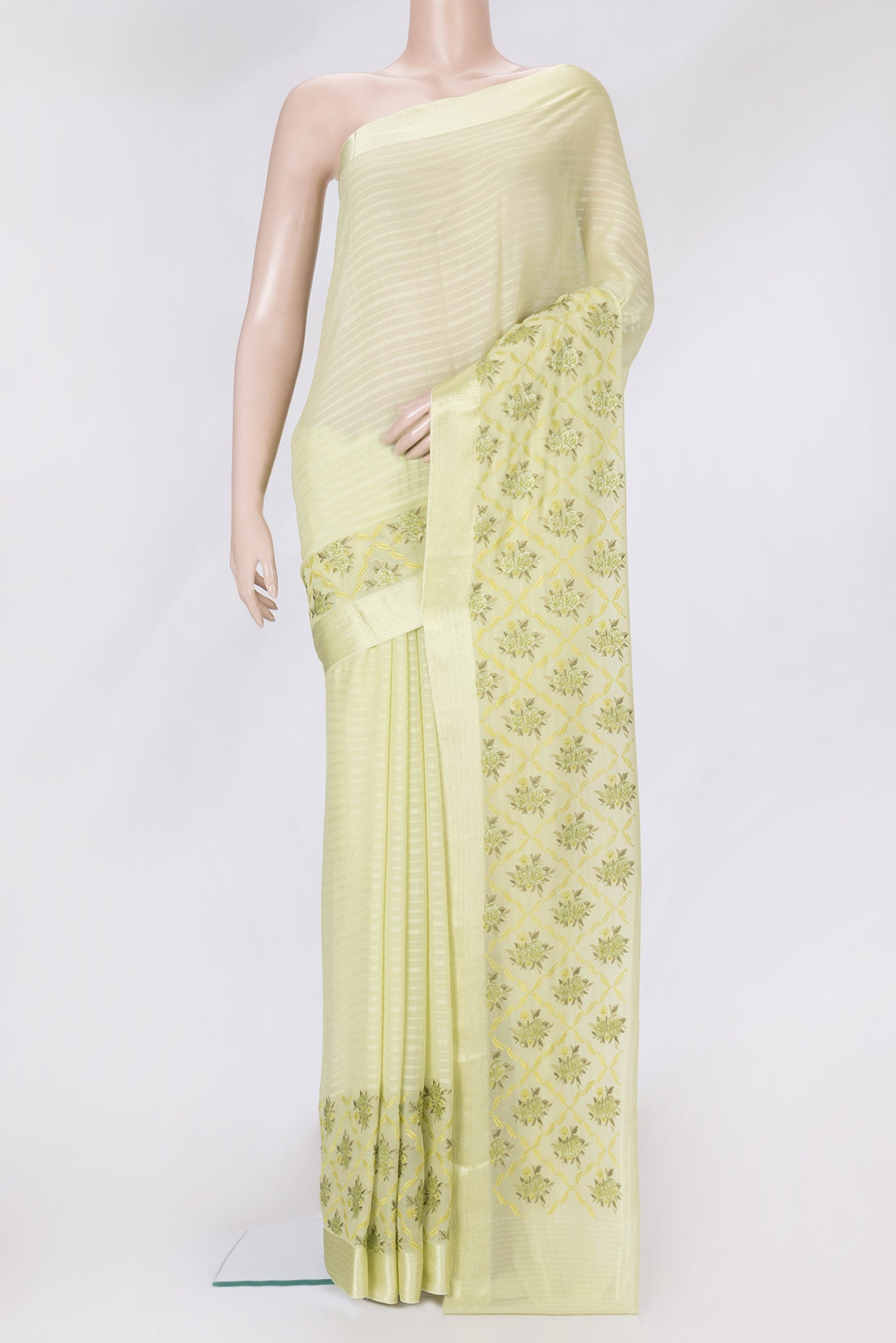 Pista Green Dual Tone Mysore Chiffon Saree with Stripes on the body and Embroidery Border.  displayed on a mannequin