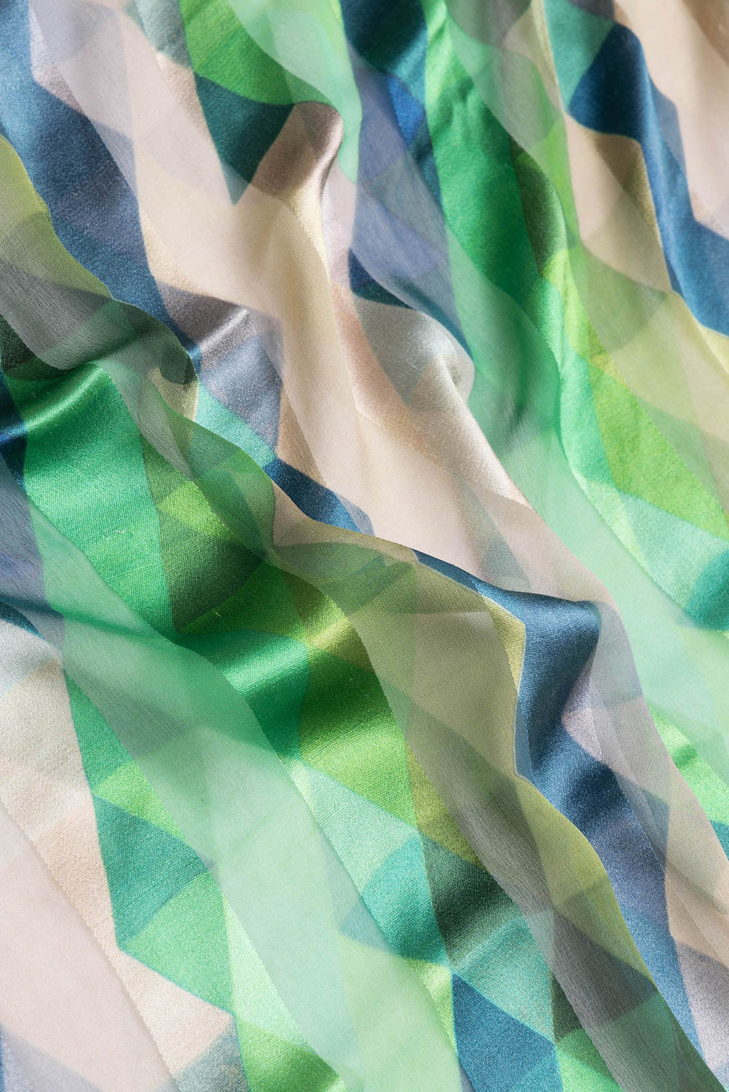 Close up of Green Dual Tone Mysore Crepe Saree with Printed design on the body and Zari Border.  displaying folds