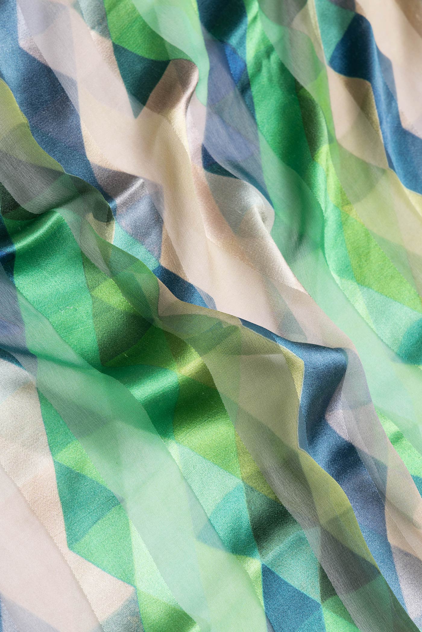 Close up of Green Dual Tone Mysore Crepe Saree with Printed design on the body and Zari Border.  displaying folds