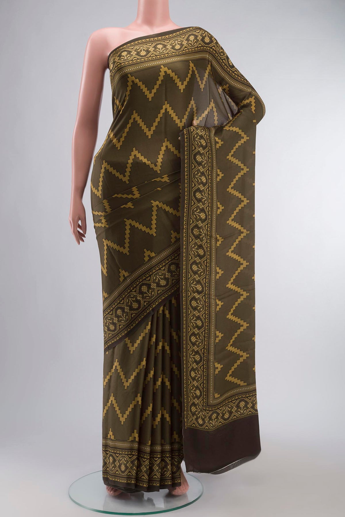 Green Satin Silk Saree with Abstract Print on the body and Printed Border displayed on a mannequin